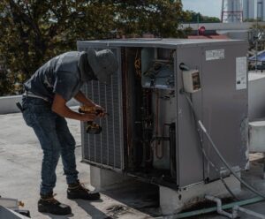 technician inspecting outdoor air conditioner unit