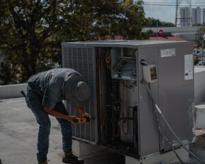 hvac technician inspecting blower motor air handler