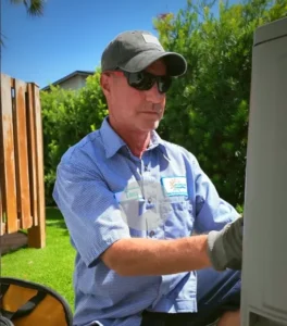 HVAC technician inspecting outdoor air conditioning unit