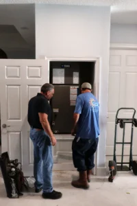 technician inspecting attic ductwork with flashlight